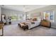 Spacious bedroom with multiple windows offering natural light, neutral decor, and comfortable furniture at 14626 Horse Trot Rd, Lithia, FL 33547