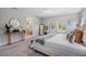 Relaxing bedroom with large windows, neutral colors, and a glimpse into the ensuite bathroom at 14626 Horse Trot Rd, Lithia, FL 33547