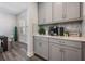 Butler's pantry area with built-in cabinets, quartz countertops, and stylish backsplash at 14626 Horse Trot Rd, Lithia, FL 33547