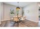 Inviting dining room with a round table, modern chairs, ample natural light, and a decorative pendant light at 14626 Horse Trot Rd, Lithia, FL 33547