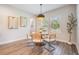 Cozy dining room featuring a round wood table, comfortable seating, and natural lighting at 14626 Horse Trot Rd, Lithia, FL 33547