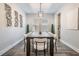 Dining room with a dark wood table and modern light fixture above, bright airy feel at 14626 Horse Trot Rd, Lithia, FL 33547