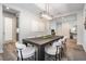 Dining room with a dark wood table and modern light fixture above, bright airy feel at 14626 Horse Trot Rd, Lithia, FL 33547