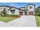 Beautiful two-story home with two-car garage, well-maintained lawn, and stone accents at 14626 Horse Trot Rd, Lithia, FL 33547