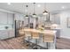 Bright kitchen with stainless steel appliances, large island with seating and modern pendant lighting at 14626 Horse Trot Rd, Lithia, FL 33547