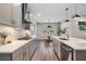 Gourmet kitchen featuring stainless steel appliances, custom cabinetry, and modern lighting at 14626 Horse Trot Rd, Lithia, FL 33547