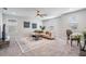 Cozy living room with plush carpet, neutral sectional, and large windows for ample natural light at 14626 Horse Trot Rd, Lithia, FL 33547