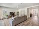 Comfortable living room featuring neutral tones, a large sectional couch, and lots of natural light at 14626 Horse Trot Rd, Lithia, FL 33547