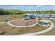 Lithia, Florida community playground area with slides, swings, and covered picnic area overlooks a serene lake at 14626 Horse Trot Rd, Lithia, FL 33547