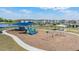 A community playground featuring slides, swings and covered picnic tables, surrounded by a lake at 14626 Horse Trot Rd, Lithia, FL 33547