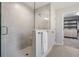 Walk-in shower featuring tile surround, shower bench and access to a walk-in closet for optimal relaxation at 14626 Horse Trot Rd, Lithia, FL 33547