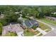 Aerial view of the home with a dark roof, well-manicured lawn, and mature landscaping at 15846 Glenarn Dr, Tampa, FL 33618
