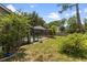 Lush backyard features mature trees and partial view of a screened-in pool at 15846 Glenarn Dr, Tampa, FL 33618
