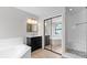 Bright bathroom showcasing a vanity, tub, shower, and sliding glass door at 15846 Glenarn Dr, Tampa, FL 33618