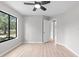 Bright bedroom showcasing large windows, a ceiling fan, and a bathroom at 15846 Glenarn Dr, Tampa, FL 33618