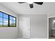Bedroom with a neutral color palette, large window, and ceiling fan at 15846 Glenarn Dr, Tampa, FL 33618