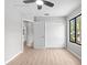 Bright bedroom featuring light floors, a ceiling fan, a window and access to closets and hallway at 15846 Glenarn Dr, Tampa, FL 33618