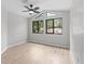 Bedroom with large windows, ceiling fan and neutral walls at 15846 Glenarn Dr, Tampa, FL 33618