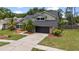 Charming home with a well-maintained front yard, mature landscaping, and attached two-car garage at 15846 Glenarn Dr, Tampa, FL 33618