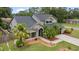 Charming two-story home with well-maintained landscaping, stone facade, black shingle roof, and a two car garage at 15846 Glenarn Dr, Tampa, FL 33618