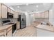 Well-equipped kitchen features stainless steel appliances, wood floors, and ample cabinetry at 15846 Glenarn Dr, Tampa, FL 33618