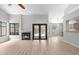 Bright living room features wood floors, fireplace, and access to the outdoor pool area at 15846 Glenarn Dr, Tampa, FL 33618