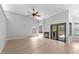 Spacious living room with lots of natural light, fireplace, ceiling fan, and sliding glass doors to backyard at 15846 Glenarn Dr, Tampa, FL 33618