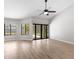 Bright living room with high ceilings, a ceiling fan, and sliding glass doors to the backyard at 15846 Glenarn Dr, Tampa, FL 33618
