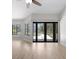 Spacious living room features wood floors and access to an outdoor pool area at 15846 Glenarn Dr, Tampa, FL 33618