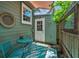 Cozy back patio area with seating, featuring a painted door and whimsical decor at 1801 52Nd S St, Gulfport, FL 33707