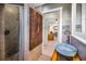 Chic bathroom with vessel sink, wood details, shower, and doorway views to living area at 1801 52Nd S St, Gulfport, FL 33707