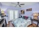 Cozy bedroom with a floral comforter, ceiling fan, and two lamps at 1801 52Nd S St, Gulfport, FL 33707