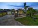 Charming bungalow home featuring lush landscaping, quaint fencing, and a welcoming walkway to the main entrance at 1801 52Nd S St, Gulfport, FL 33707