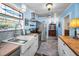 Well-lit kitchen with stainless steel appliances, butcher block counters, and a farmhouse sink at 1801 52Nd S St, Gulfport, FL 33707