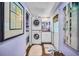 Efficient laundry room with stacked washer/dryer and storage at 1801 52Nd S St, Gulfport, FL 33707