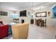 Open-concept living room with dining area, featuring tile floors, natural light, and stylish furnishings at 1801 52Nd S St, Gulfport, FL 33707