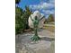 A mosaic statue of a Personal standing under a flower in a park-like setting at 1801 52Nd S St, Gulfport, FL 33707