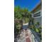 Side yard featuring an archway covered with vines, stepping stones, and white gravel at 1801 52Nd S St, Gulfport, FL 33707