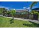 Fenced yard with tropical landscaping offering privacy and charm at 1801 52Nd S St, Gulfport, FL 33707