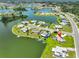 Aerial view displays home with waterfront, pool, and serene landscaping at 1811 Milford Cir, Sun City Center, FL 33573