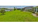 Expansive backyard with lush lawn, dock, and water views at 1811 Milford Cir, Sun City Center, FL 33573