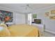Cozy bedroom with neutral walls, ceiling fan, and an ensuite bathroom at 1811 Milford Cir, Sun City Center, FL 33573