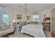 Comfortable bedroom with windows, white decor, and light wood floors at 1811 Milford Cir, Sun City Center, FL 33573