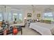 Bright bedroom with bay window, ceiling fan, and comfortable furnishings with plenty of natural light at 1811 Milford Cir, Sun City Center, FL 33573