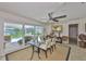 Bright dining room featuring a glass table, patio access, and views of the outdoor pool at 1811 Milford Cir, Sun City Center, FL 33573