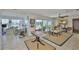 Open concept dining area leading to the pool with modern glass table and comfortable seating at 1811 Milford Cir, Sun City Center, FL 33573