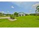 Well-maintained lawn and landscape surrounding this single-story home at 1811 Milford Cir, Sun City Center, FL 33573