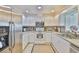 Kitchen with white cabinetry, stainless appliances, and modern countertop at 1811 Milford Cir, Sun City Center, FL 33573