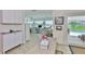 Bright kitchen flowing to a dining area that offers views of the pool at 1811 Milford Cir, Sun City Center, FL 33573
