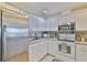 Bright kitchen with white cabinets and stainless steel appliances at 1811 Milford Cir, Sun City Center, FL 33573